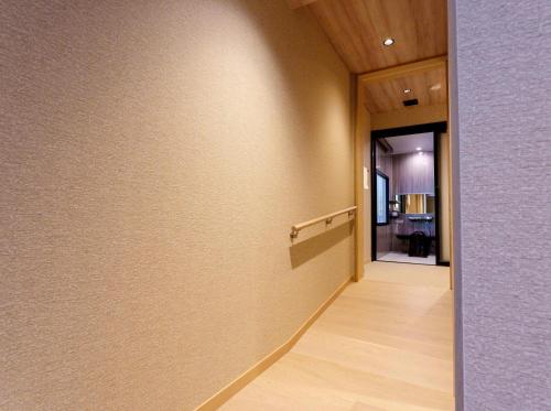 a hallway with a wall with at Kamikochi Lemeiesta Hotel in Matsumoto
