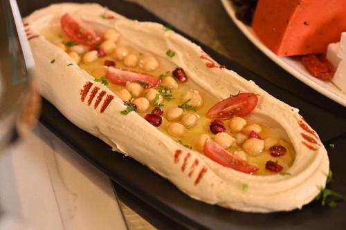 a burrito filled with beans and tomatoes on a table at Comfort Hotel Riyadh Olaya in Riyadh