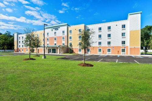 an empty parking lot in front of a building at WoodSpring Suites Pensacola West in Pensacola
