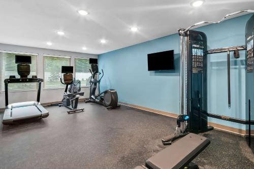 a gym with several exercise equipment in a room at WoodSpring Suites Pensacola West in Pensacola