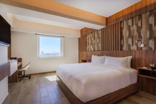 Postel nebo postele na pokoji v ubytování Radisson Puebla Angelopolis