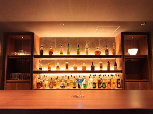 a bar with a bunch of bottles of alcohol at Kamikochi Lemeiesta Hotel in Matsumoto