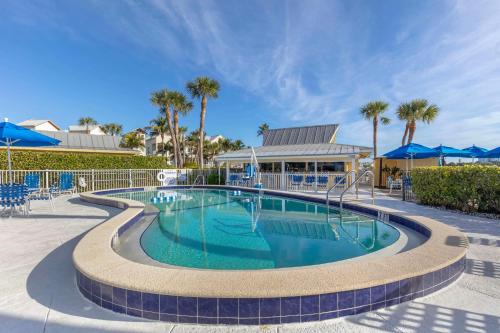 a swimming pool in a resort with palm trees at Hilton Vacation Club Charter Club Naples Bay in Naples