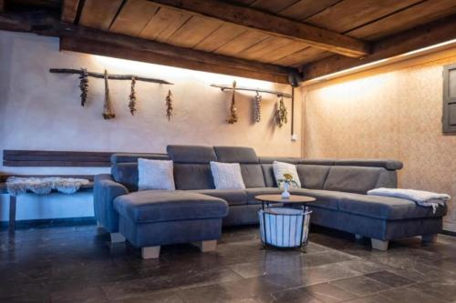a living room with a couch and a table at Luxury Chalet Martin in Grosuplje