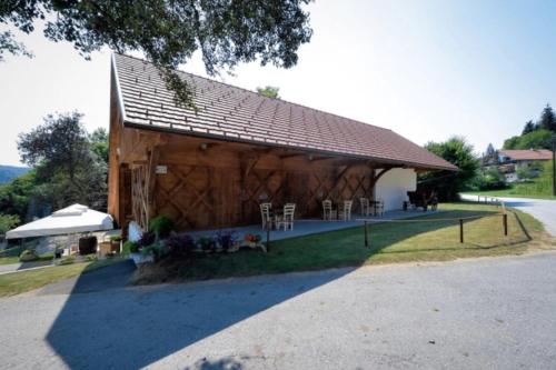 a barn with tables and chairs in front of it at Luxury Chalet Martin in Grosuplje