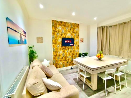a living room with a couch and a table at Liverpool 4 Bed Home Sleeps 18 Free Parking in Liverpool