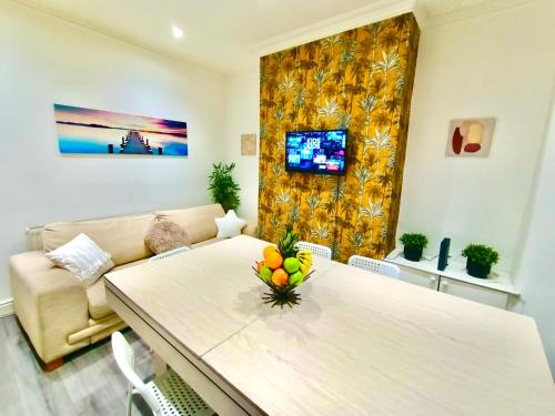 a living room with a table and a couch at Liverpool 4 Bed Home Sleeps 18 Free Parking in Liverpool