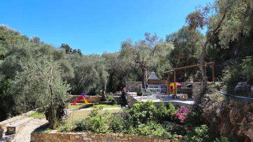 a view of a garden with trees in the background at Villas On The Rock Afissos in Afissos