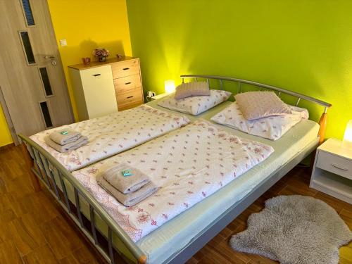 a bedroom with a bed with towels on it at Apartmán Slivková in Trenčín