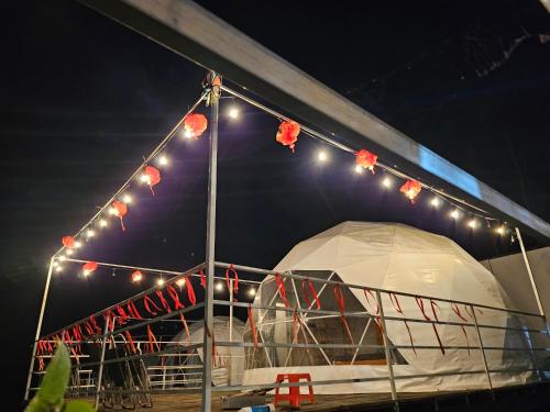 a marquee with lights on a boat at night at An Nhien garden in Bảo Lâm