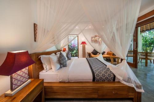a bedroom with a bed with a canopy at The Hidden Paradise Ubud - CHSE Certified in Ubud
