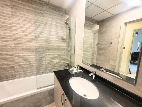 a bathroom with a sink and a mirror at Polo Residence Building C1 in Dubai