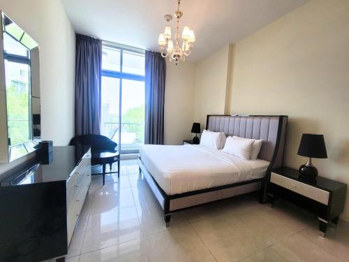a bedroom with a bed and a desk and a chandelier at Polo Residence Building C1 in Dubai
