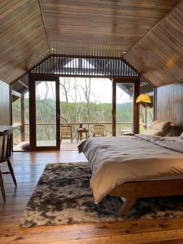 a bedroom with a large bed and a large window at KỲ VIÊN Home & Cafe in Xuân Thọ