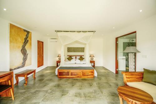 a bedroom with a bed and a couch at The Hidden Paradise Ubud - CHSE Certified in Ubud