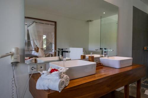 a bathroom with two sinks and a large mirror at The Hidden Paradise Ubud - CHSE Certified in Ubud