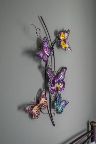 a group of butterflies on a wall at Vista Verde Studios & Apartments in Svoronata