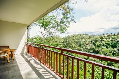 a balcony with a view of the forest at The Hidden Paradise Ubud - CHSE Certified in Ubud