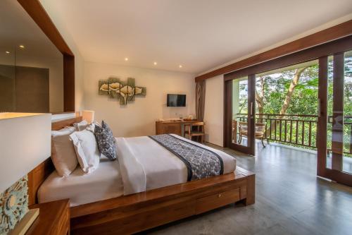 a bedroom with a large bed and a balcony at The Hidden Paradise Ubud - CHSE Certified in Ubud