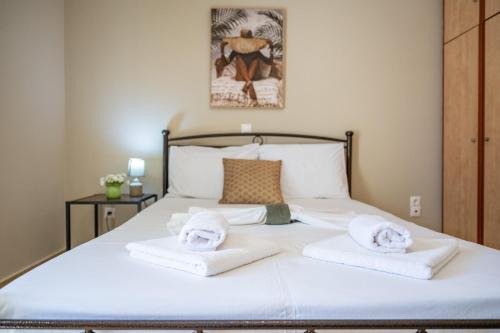 a bedroom with a bed with towels on it at Vista Verde Studios & Apartments in Svoronata