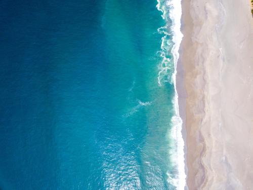 an aerial view of the ocean and the beach at Hotel Noto Marina Vista Mare in Noto Marina