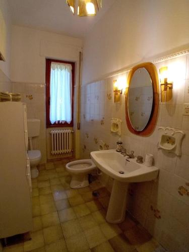 a bathroom with a sink and a toilet and a mirror at Big apartment between Bologna and Florence in Mercatale Vernio