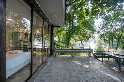 a glass house with a view of the street at Puprai Tarnnarm Resort in Thong Pha Phum