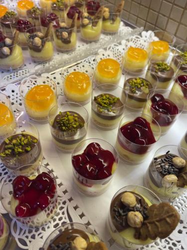 a table with many different types of food in glass bowls at Deluxe Dina in Skala Potamias
