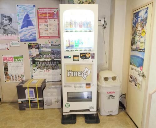 a drink vending machine in a store with a drink cooler at Business Hotel Takizawa Takasaki Station Nishiguchi in Takasaki
