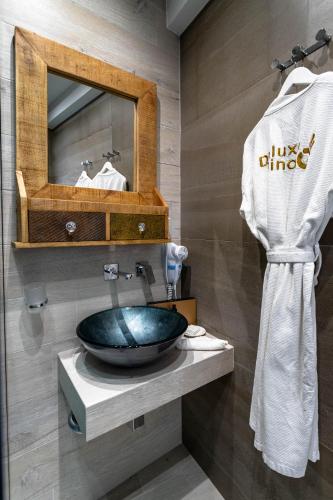 a bathroom with a sink and a mirror at Deluxe Dina in Skala Potamias