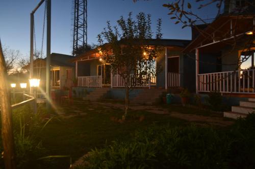 a house with lights on the front of it at Namaha hotel and cottages in Kanatal