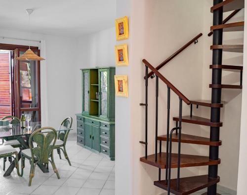 a staircase in a living room next to a dining room at Casa di Bruca in Marinella di Selinunte