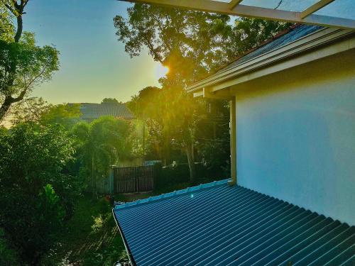 a balcony of a house with a view of the sunset at Margosa villa in Tangalle