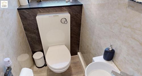 a bathroom with a white toilet and a sink at Haus Kirijan in Garbsen