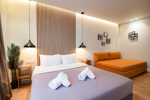 a bedroom with a large bed with two towels at Still Athens in Athens