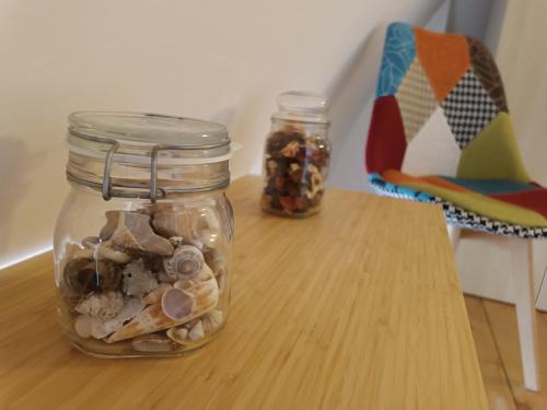 two mason jars filled with shells on a table at B&B San Francesco in Molfetta