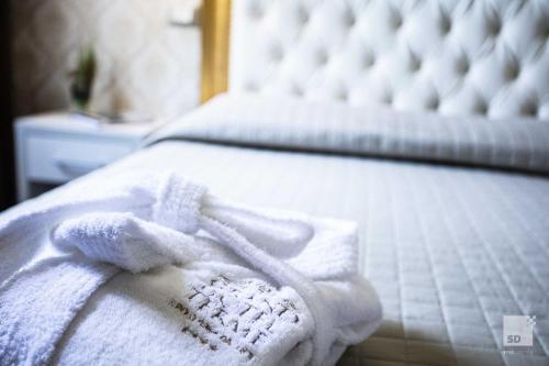 a bed with white towels sitting on it at Grand Hotel Terme in Riolo Terme