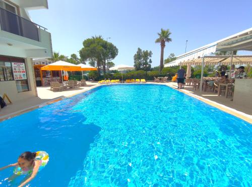a little girl swimming in a swimming pool at Mulka Hotel in Ayvalık