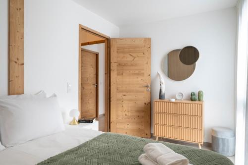 - une chambre avec un lit et une porte en bois dans l'établissement Appartement Cabane des Neiges, aux Gets