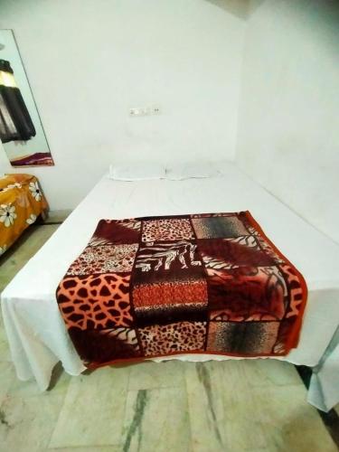 a table with a blanket on top of it at Shivay Guest house in Jasidih