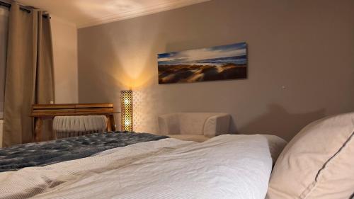a bedroom with a bed and a picture on the wall at Haus Kirijan in Garbsen