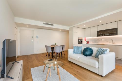 a living room with a white couch and a table at Splendid Apartment with a Terrace in Vila Nova de Gaia