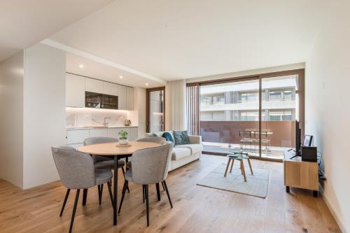 a living room with a table and chairs and a couch at Splendid Apartment with a Terrace in Vila Nova de Gaia