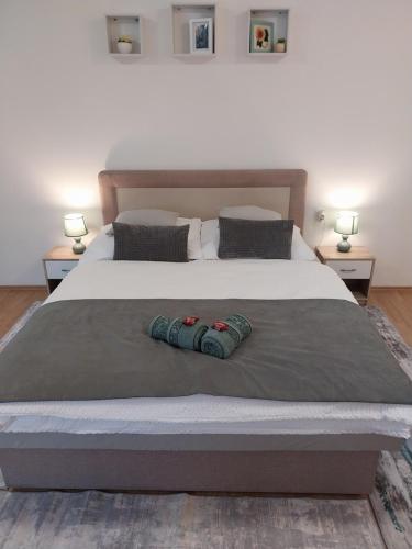 a large bed with two pillows on top of it at Repi-Tár apartman in Szolnok