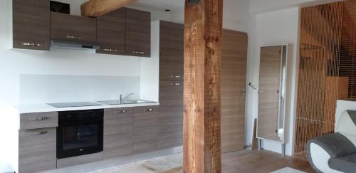 a kitchen with wooden cabinets and a sink at Villa Solary in Le Pontet