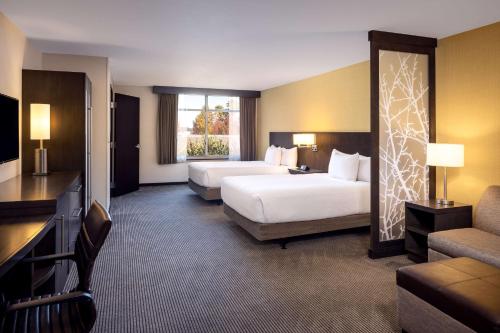 a hotel room with two beds and a couch at Hyatt Place Santa Cruz in Santa Cruz