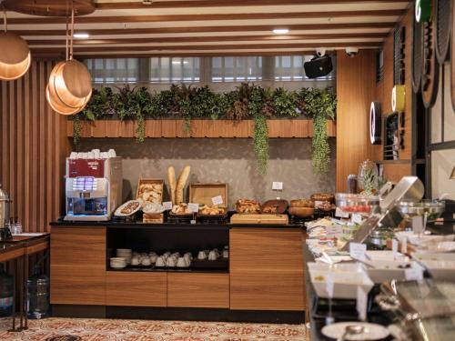 a restaurant with a counter with food on it at Mercure Istanbul Sirkeci in Istanbul