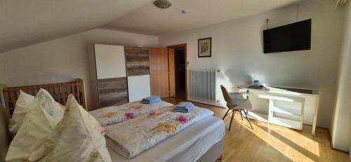 a bedroom with a bed and a desk in it at Ferienwohnung Pirker in Spittal an der Drau
