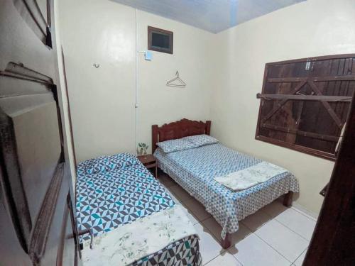 a room with two beds in a room at Algodoal Casa Verde in Maracanã