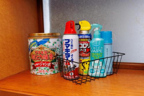 a shelf with a group of condiments on a table at オーシャンビューの絶景UnclesHouse海の宿は美ら海水族館近く1棟貸 in Motobu